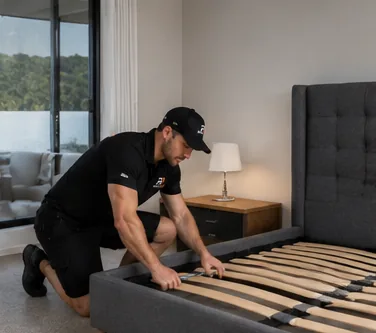 Route One team member assembling a bed frame